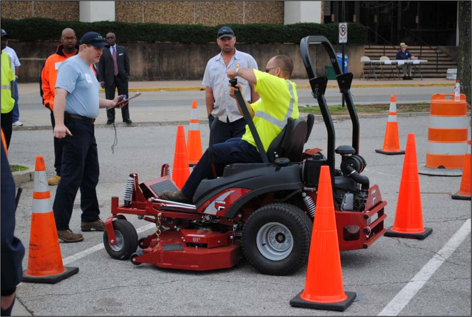 Town of Vinton employee Mike ensuring all participants buckled up for safety in the Zero Turn Mower event.